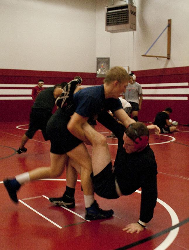 Fresno City College wrestlers Josh Van Haaster (right) and Spencer Hill grapple in the wrestling room at FCC to prepare for an upcoming match.