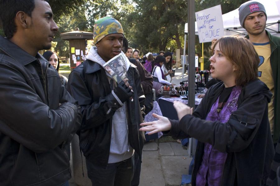 Counterprotestor Kayci Harris (right), debates against anti-abortion protests (left)