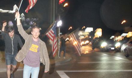 Jeremiah Lee, 25, runs across the intersection of Shaw and Blackstone after the announcement of Bin Ladens death.  He said he had the need to celebrate with the rest of the country.