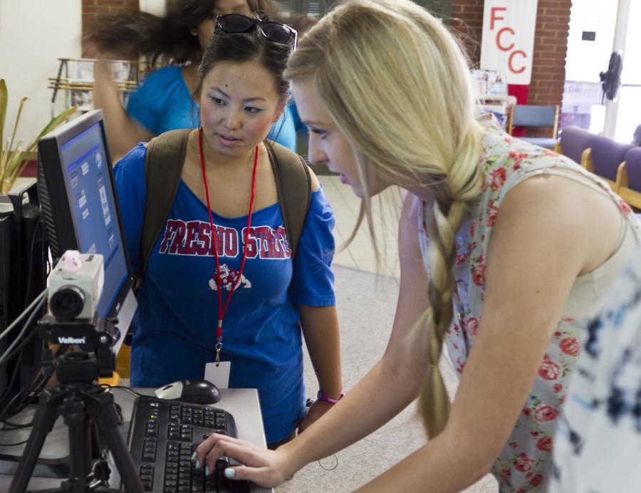 (Left to Right) ASG Senators Foua Vang, Rachel McKinley work the Associated Student Body card machine.