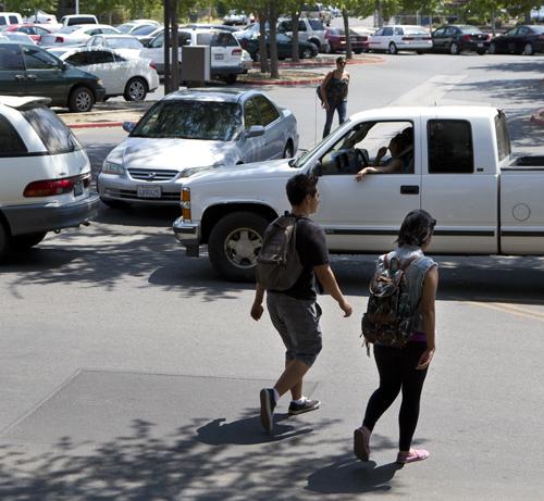 Students walk towards the parking lot while cars are stalled while waiting to exit Fresno City College on Tuesday, August 14., 2012 (Archive Photo)