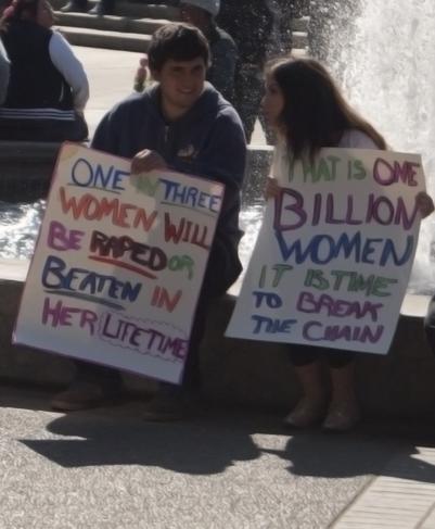 Photo by Karen West. Bara Diab and Delaney Olmo offer statics of violence against women on Feb. 14.