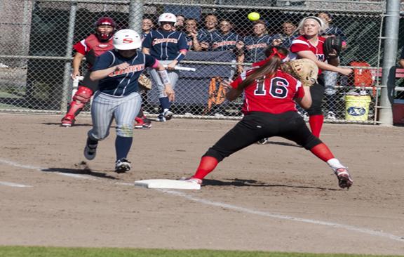 The Rams Grace Combs, Pitcher, and Dana Moritz, First Base, make the play at first against the Sequoias Giants  on Feb. 28. (Photo/Karen West)