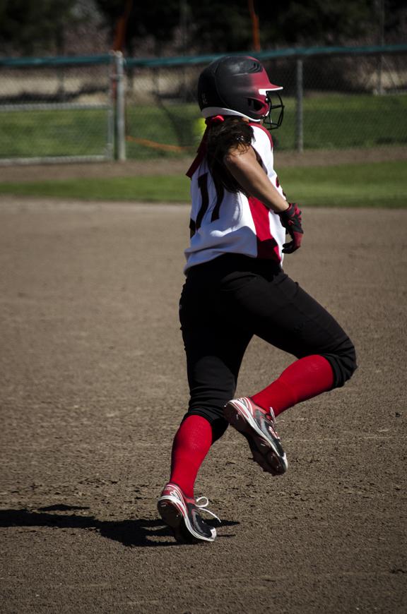 Photo by Michael Monroy. Fresno City College Rams Kyla Cisneros makes a home-run and runs all the plates against Reedley College Tigers, during a softball game on Thursday March 21.