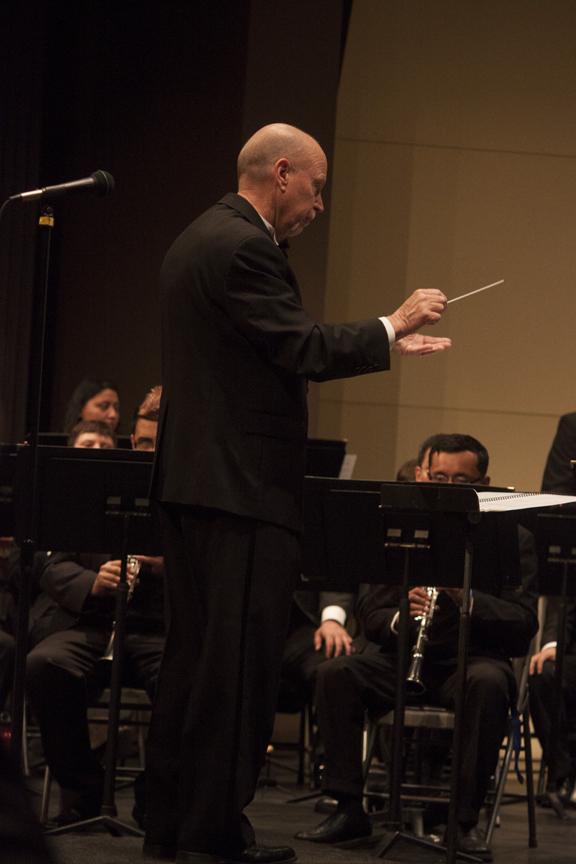 Photo by Darlene Wendels. Gary Gilroy, conductor and instructor from Fresno State, conducts the Fresno City College Concert band on March 13.
