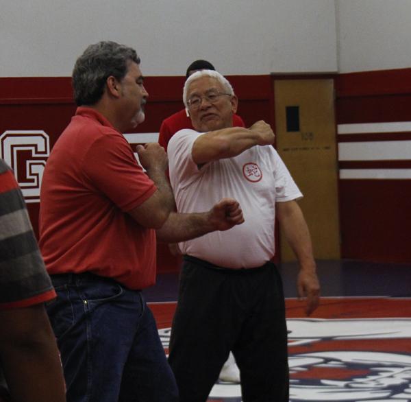 John Cho, Fresno City College Asian American Studies instructor demonstrates martial art moves to FCC students with the assistance of Dan Lopez on April 12, 2013. (Photo/Kevynn Gomez)