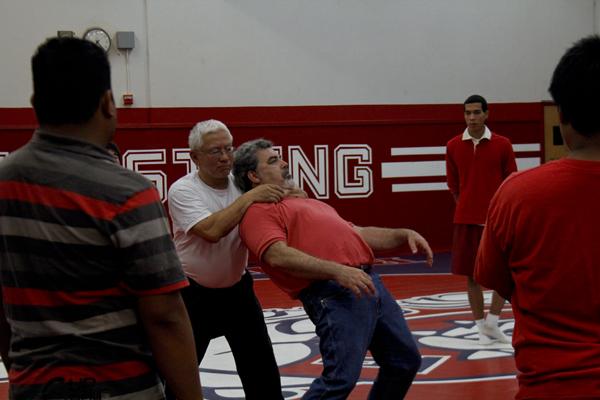 John Cho, Fresno City College Asian American Studies instructor demonstrates martial art choke hold move to FCC students with the assitance of Dan Lopez on April 12, 2013.  (Photo/Kevynn Gomez)