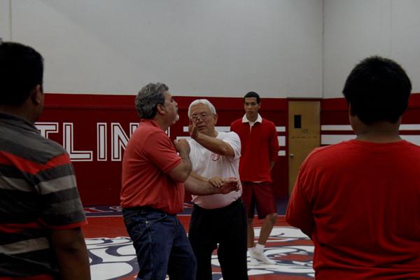 John Cho, Fresno City College Asian American Studies instructor demonstrates martial art defensive move to FCC students with the assitance of Dan Lopez  on April 12, 2013.  (Photo/Kevynn Gomez)