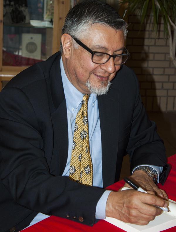 Dr. David E. Hayes-Bautista, Professor at The University of California, Los Angeles Medical School and author of El Cinco de Mayo: An American Tradition”, signing a book for a Fresno City College student at a book signing held on May 1, 2013 in FCCs Old Administration Building after discussing the origins of the Cinco de Mayo holiday.(Photo/Darlene Wendels)