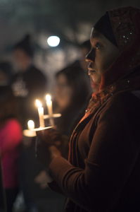 A woman holds a candle at a vigil remembering the life of civil rights leader, Martin Luther King on Jan. 17, 2015.