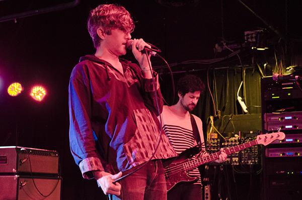  We are Scientists’ Keith Murray (front) sings to the crowd while Chris Cain (back)  plays on bass at Strummer’s, April 27, 2015. 