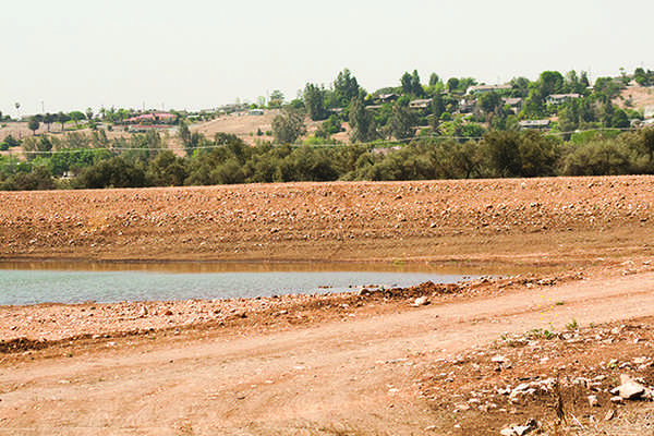 Houses sit on Snob Hill in Porterville, California as dry grass and low water levels are evident due to the drought. Many households have stopped watering their lawns due to restrictions.