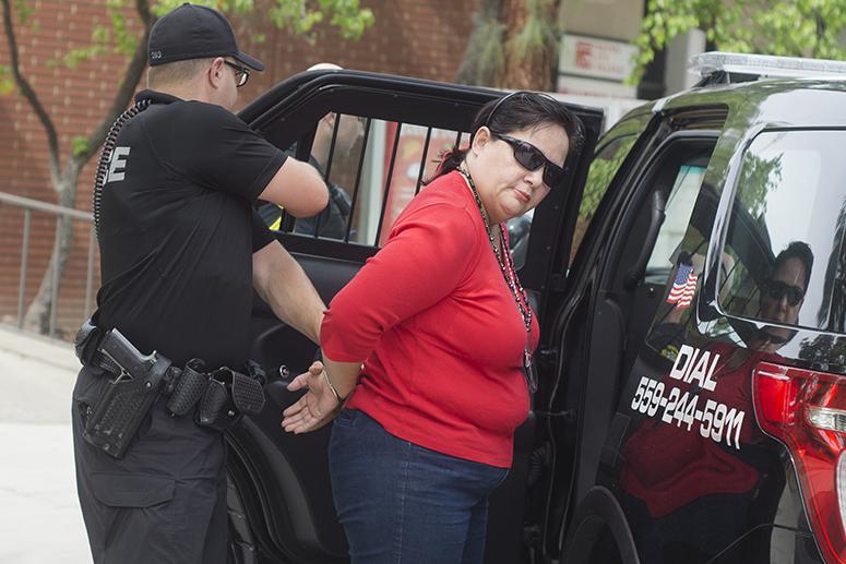 Linda Sanchez, Student Activities accounting clerk being arrested by the State Center Community College District Police after an altercation with a student aide in the student lounge on March 20, 2015. 