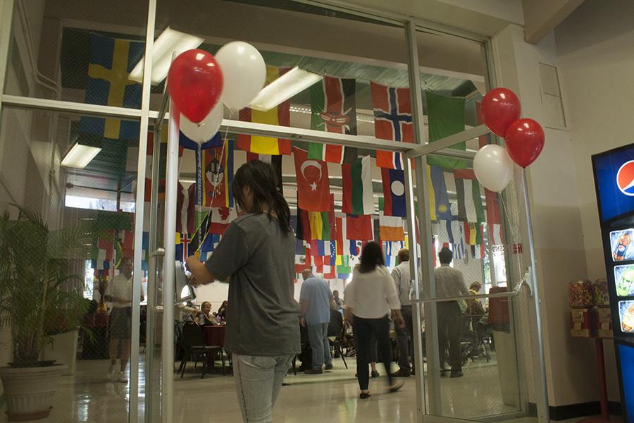 A student places red and white balloons at the entrance of the Fresno City College cafeteria during the  Fall 2015 Convocation which kicked off the new semester. The new Interim President, Cynthia Azari was welcomed by the college. August 13, 2015.