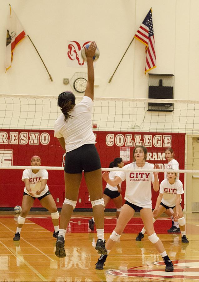 Players practice spiking over the net for harder and more precise hits, at FCC Gymnasium on Monday, Aug. 31, 2015.