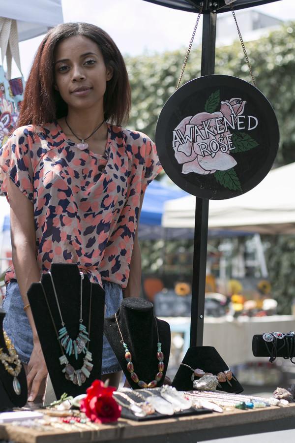 Awakened Rose founder and creator, Tayler Jenkins, posing next to her creations at the Artisan Faire at Mia Cuppa Caffe in Tower District. Sept. 13, 2015. 