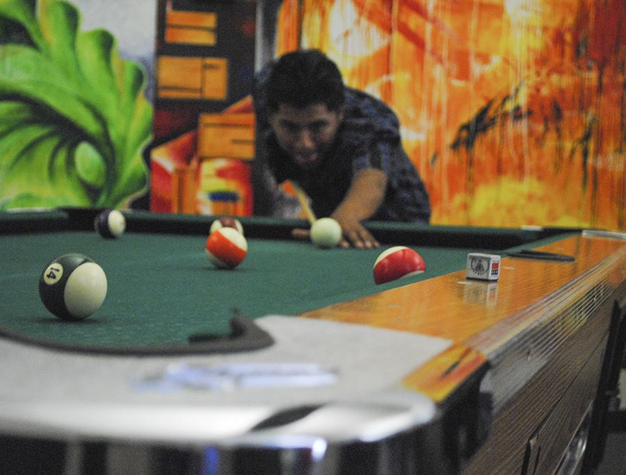 Student playing pool during his lunch break in the Game Room on Fresno City Campus. Monday, Oct. 5, 2015. 