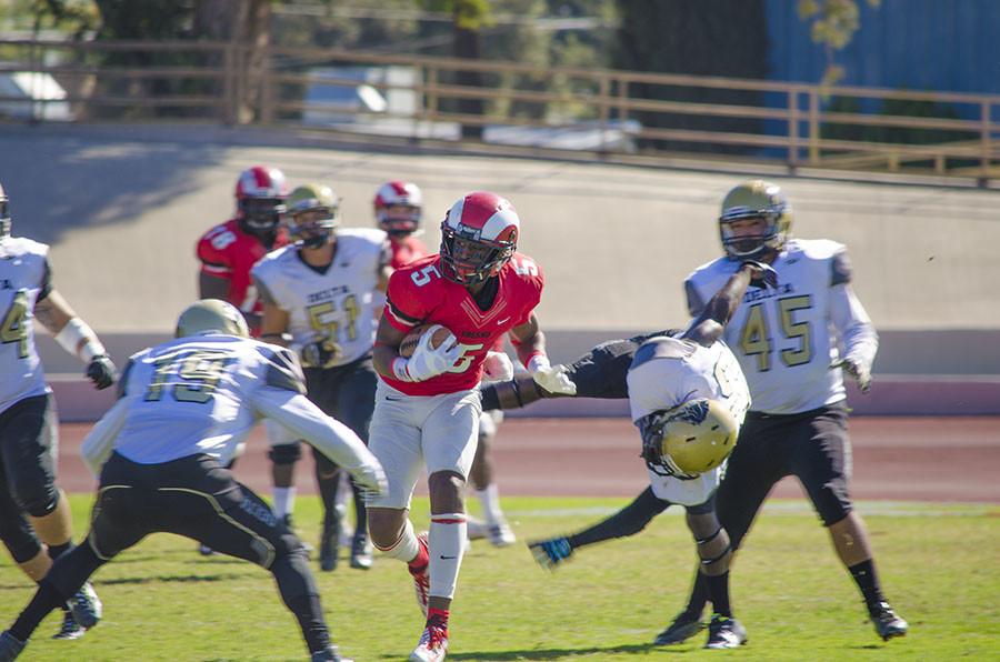 Wide receiver James Whitfield, of Fresno City College, looks for an opening and evades running back Javaughn Iverson of San Joaquin Delta College at Ratcliffe Stadium at the homecoming game Oct. 31, 2015. 