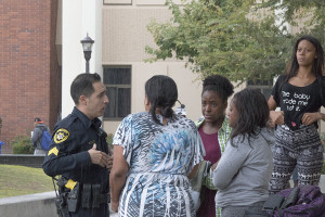 A State Center Community District Police officer speaks with one of the females involved in one of two fights that broke out in the Free Speech Area on Nov. 9.