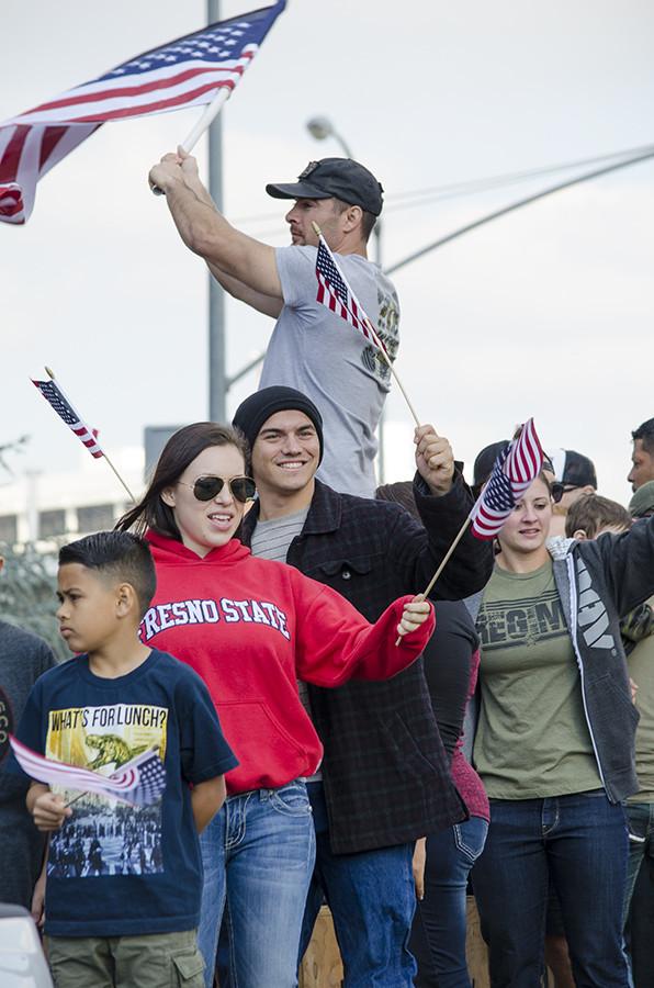 Supporters of U.S. veterans wave their flags at the Veterans Day Parade, starting from Fresno City Hall and ending at Chukchansi Park, Wednesday, Nov. 11, 2015.