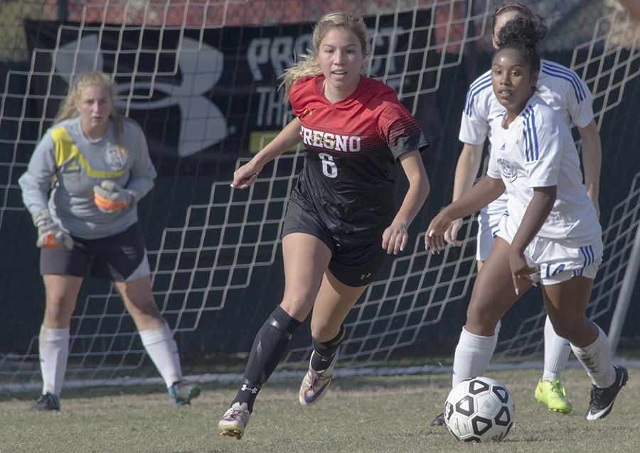 Denisse Aguirre battling with Solano forward Nicolette Nesmith.