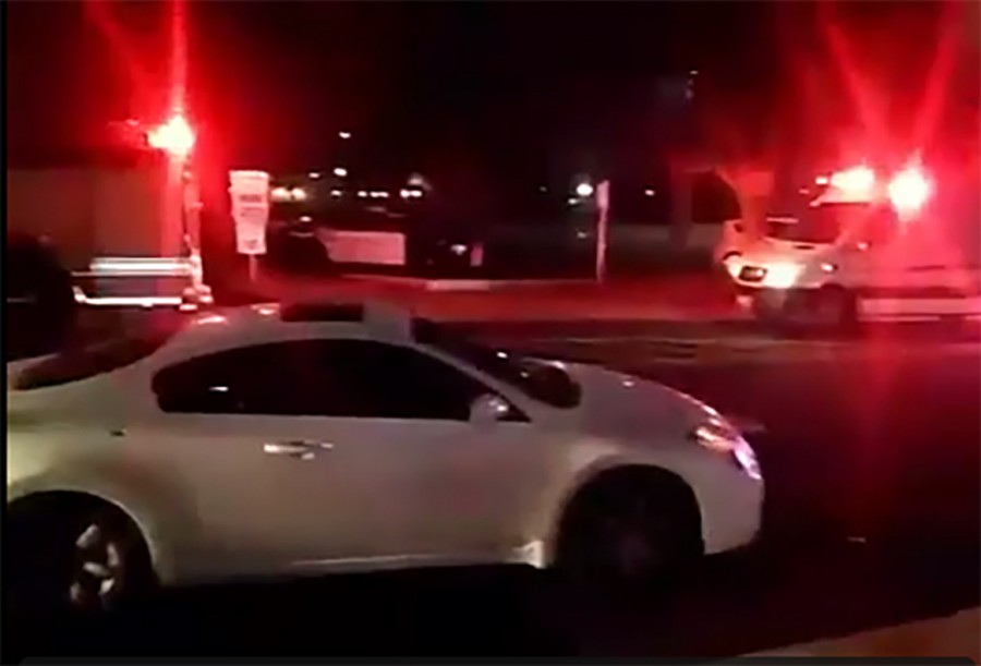 A vehicle with a bullet hole on its right side stands on campus after being caught in the crossfire between two other vehicles near Fresno City College on Jan. 12, 2016. 