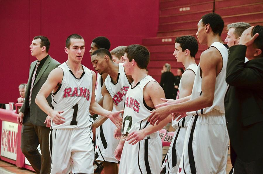 Sophomore Guard Nick Hilton gets support from his teammates as he heads to the bench. Saturday, Jan. 25, 2015.  