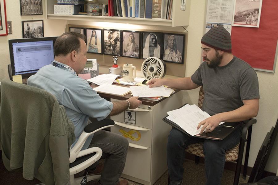 Veteran and philosophy student Brian Moreland (right) gets help from counselor Mario Reposo (left) at the FCC Veterans Center. The center celebrates its one year anniversary.   