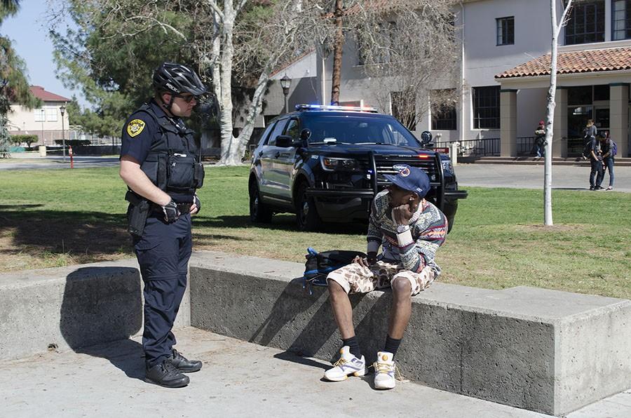 SCCCD Police speak with a man after an altercation in the Fresno City College Free Speech Area on Feb. 25, 2016.