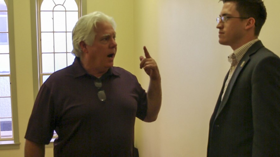 Ted Miller confronts Cody Sedano on the staircase of the left wing of the OAB on Feb. 23, 2016. Photo/ Larry Valenzuela