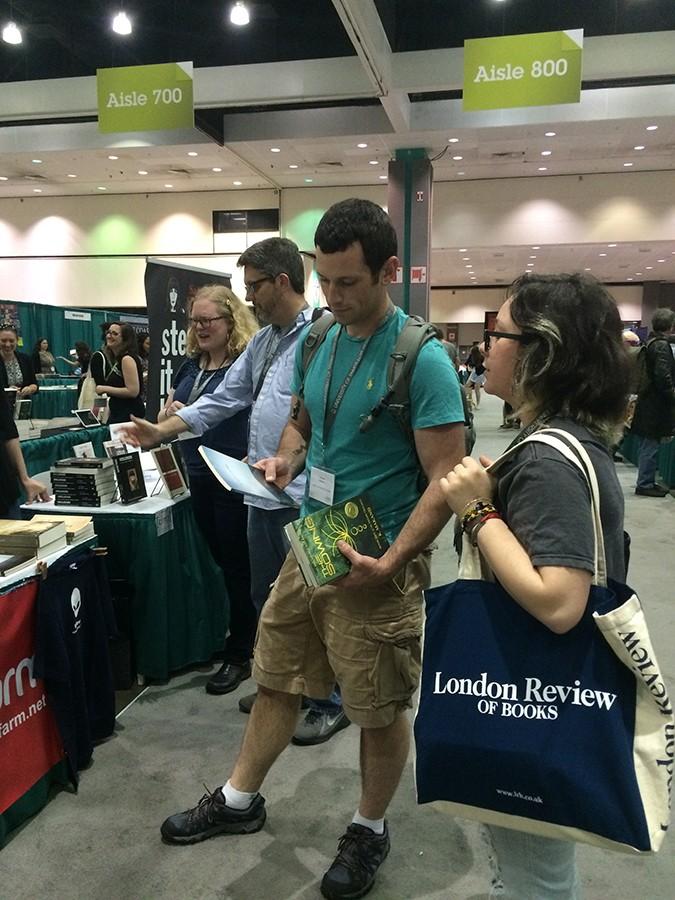 FCC student Thomas Childress and Damiann Cardenas look through the book fair at the 2016 AWP Conference April 1, 2016.