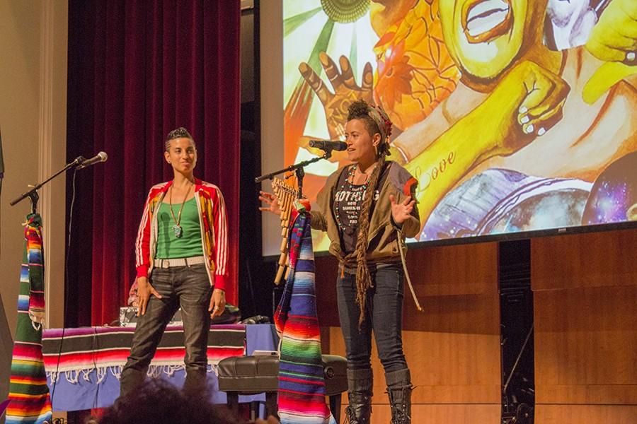 Alixa Garcia and Naima Penniman stand on stage at the Fresno City Colllege Auditorium while performing poetry. 