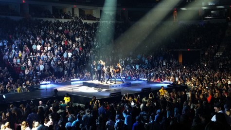 Luke Bryan and band performs together at the front of the stage at the Save Mart Center in Fresno, Calif. on April 30, 2016