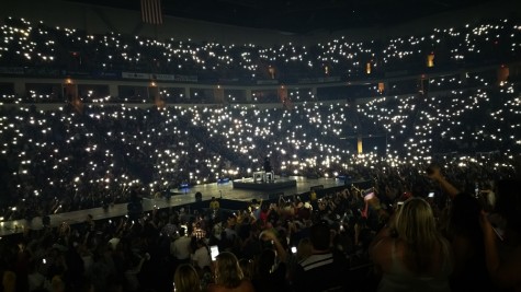 Fans' cell phones serve as the light source while Luke Bryan performs "Drink A Beer" at the Save Mart Center in Fresno, Calif. on April 30, 2016, a song that deals with losing a loved one.