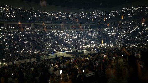 Fans' cell phones serve as the light source while Luke Bryan performs "Drink A Beer" at the Save Mart Center in Fresno, Calif. on April 30, 2016, a song that deals with losing a loved one. 