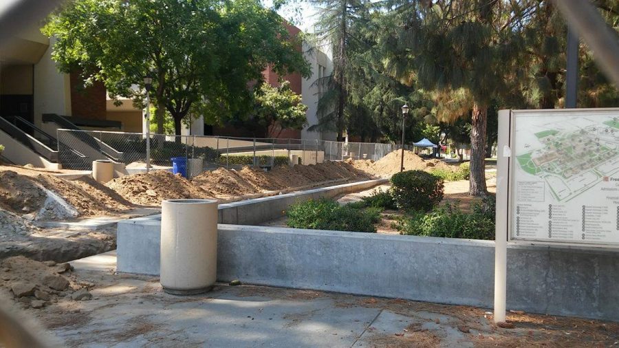 Dirt piles sit along a trench that was dug up around the southeastern portion of the Forum Hall building.