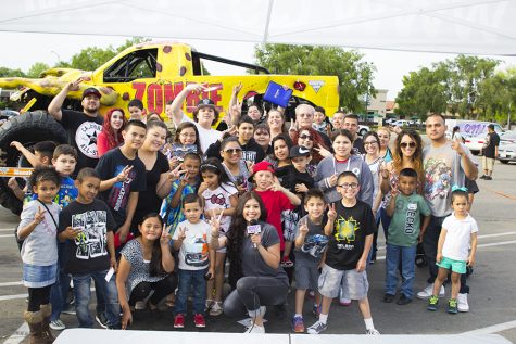 Kimberly Marquez takes a group picture with listeners during a "remote" for Q97.1 FM at a Metro PCS store in Fresno, Calif. on April 7, 2016