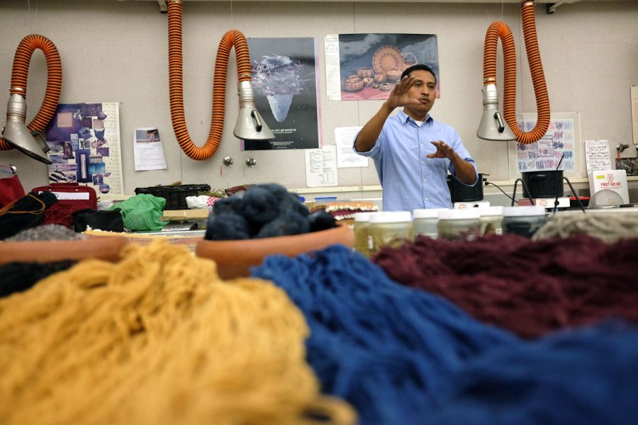 Porfirio Guitierrez explaining his natural dye process for his yarn used for his weavings in T-101 at Fresno City College on Aug. 25, 2016