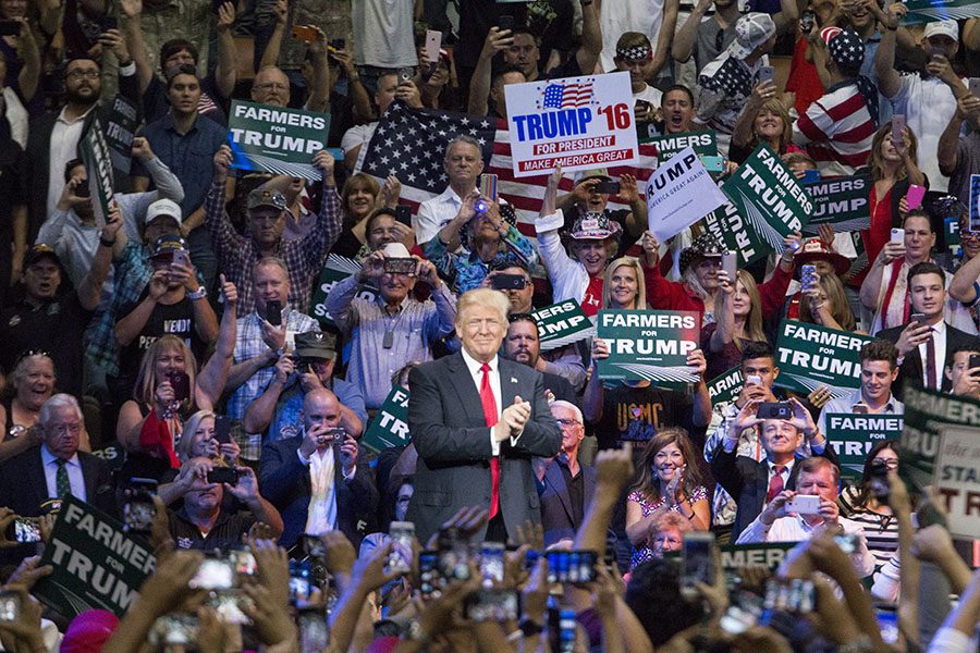 Donald Trump stands in the middle of supporters during a visit to Fresno on May 27, 2016. 