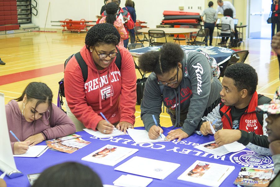 Students gather around the Wiley College table at the Historically Black Colleges and Caravans event in the FCC gym on Tuesday, Feb. 14, 2017