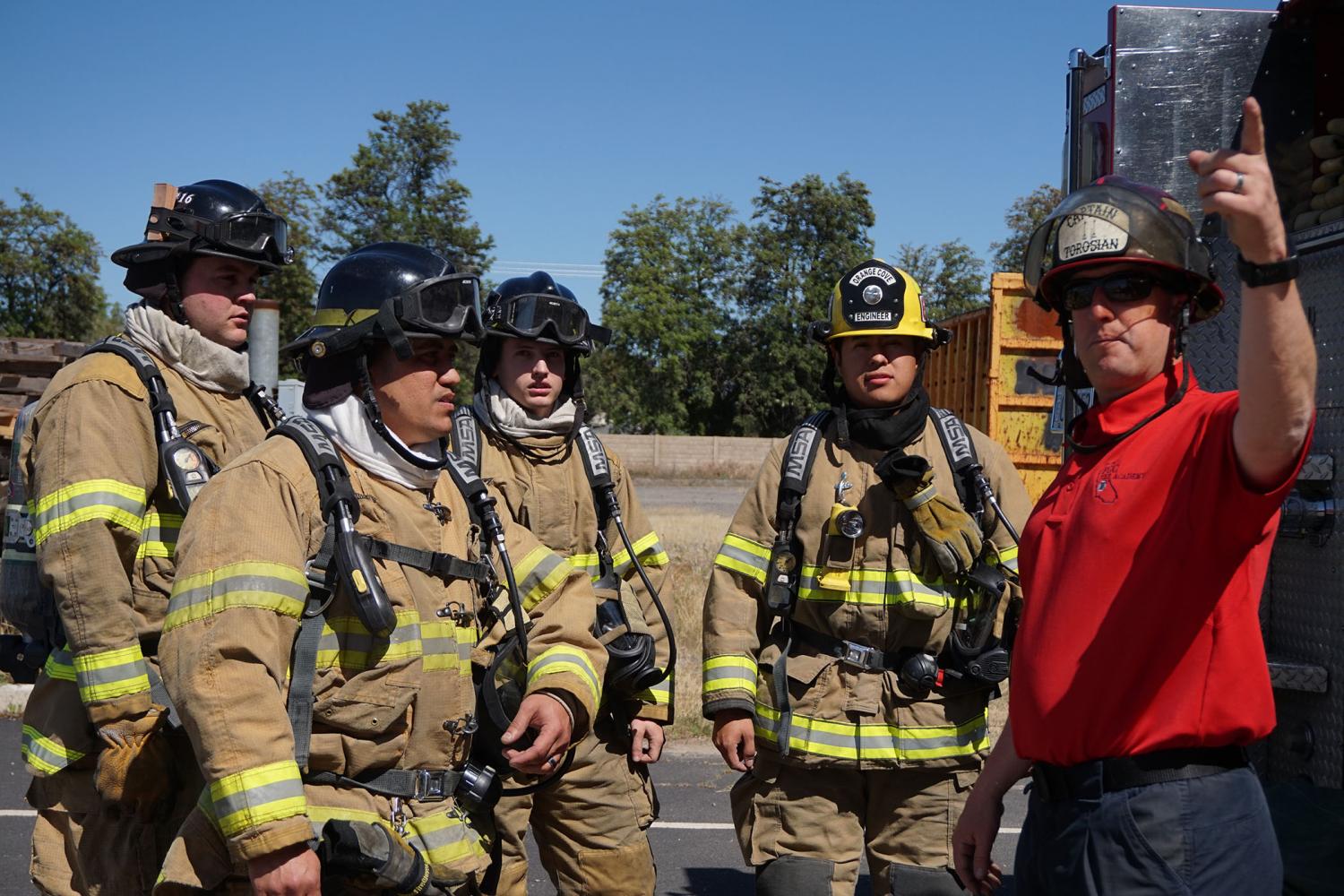 An instructor explains to the Fresno City College Fire Academy students what they need to do to salvage a simulated second story apartment at the Clovis Fire Training Center on Saturday, April 29, 2017