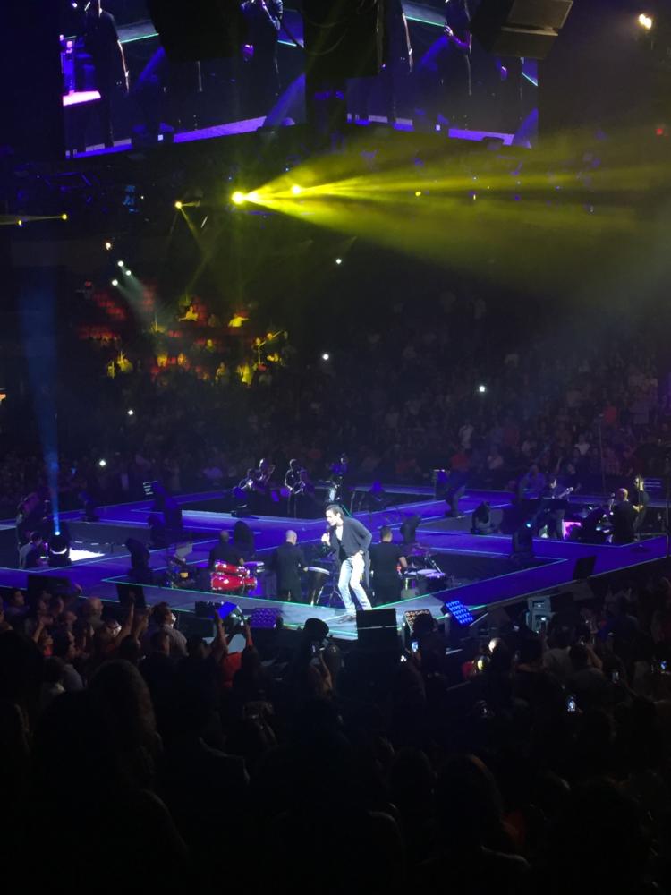 Marc Anthony singing with his band at the Save Mart Center