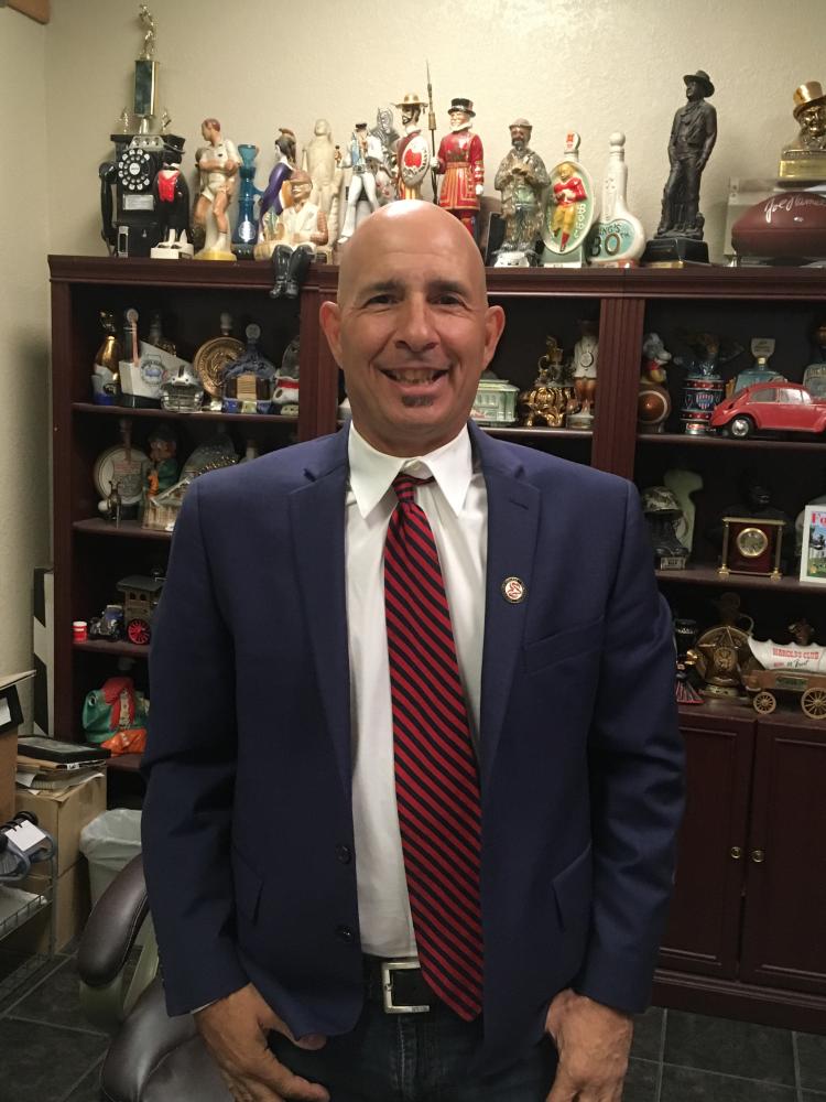 Edward Papulias, owner of Pappys Fine Foods, in the office of his established business donning his FCC Pin on Sept. 19, 2017.