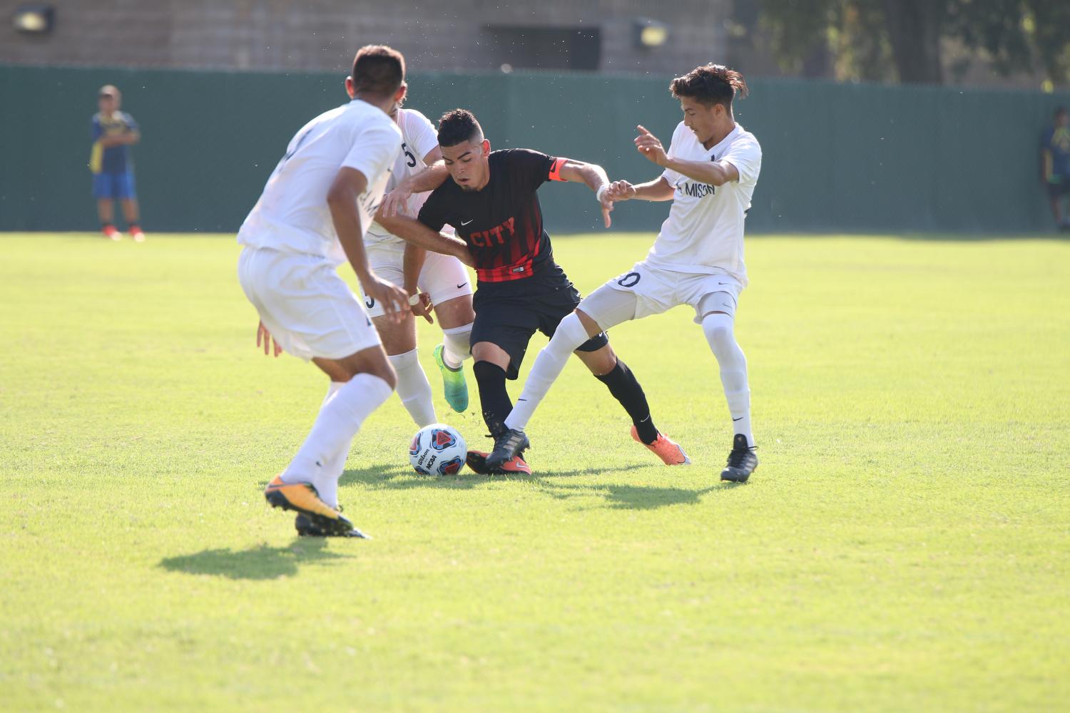 Rams forward Johnny Rodriguez trying to get away from three LA Mission defenders on Sept. 8.