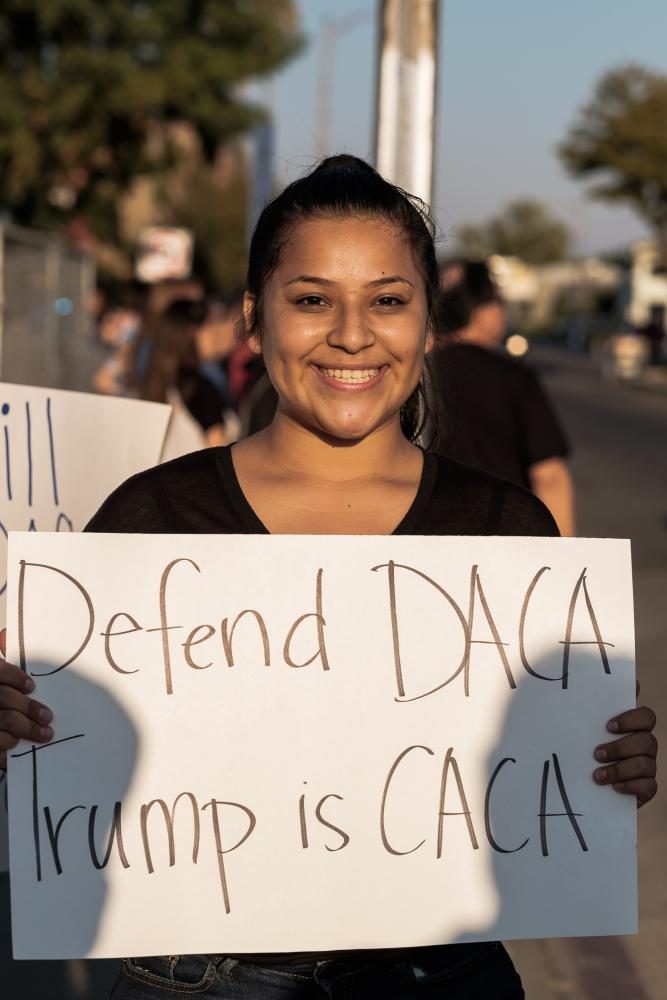 I am a high school student and I see others students who are under DACA and that go to school to my school. I saw how they had improved their lives, they learn how to speak English and a lot of things that they werent able to do when they got here. Genesis Parra holds up a sign during the March to Defend DACA at Fresnos Tower District on Sunday, Sept. 15, 2017.