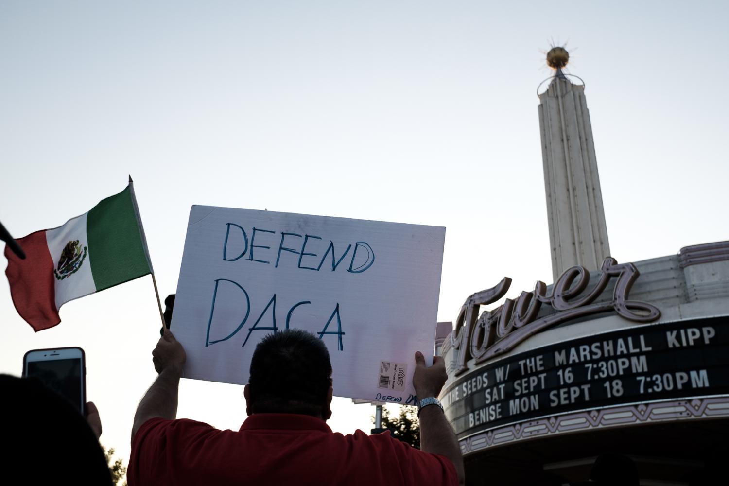 A+protester+holds+up+a+sign+as+they+walk+down+Olive+avenue+for+the+March+to+Defend+DACA+at+Fresnos+Tower+District+on+Sunday%2C+Sept.+15%2C+2017.