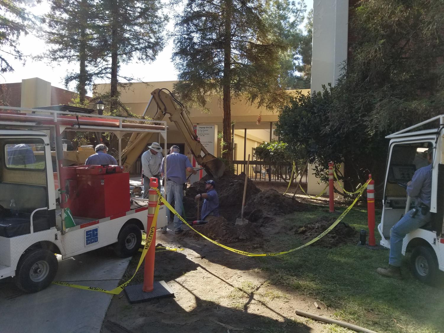 Maintenance crews work on a chilled water line leak near the Language Arts building at Fresno City College on Wednesday, Oct. 25, 2017.
