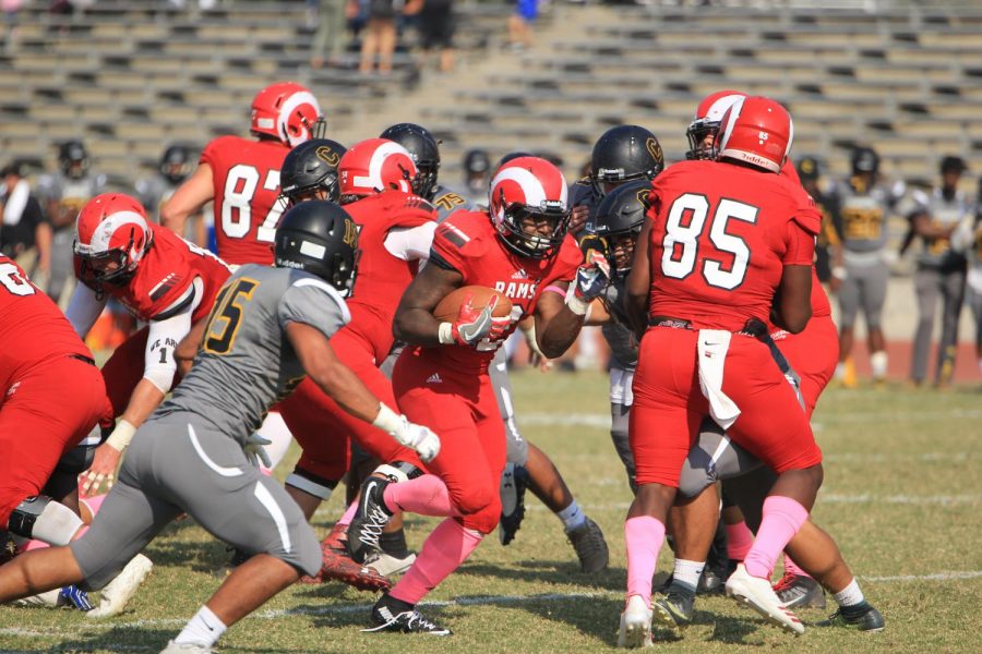 Fresno City College running back Khai Williams gets through the Chabot Colleges defensive line during homecoming game at Ratcliff stadium on Saturday, Oct. 14, 2017.