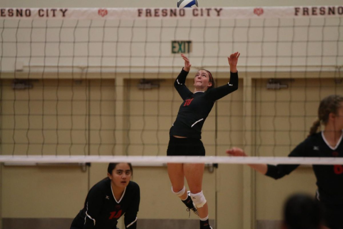 Fresno City College outside hitter Katie Emmerling serves up a ball during a home game on Wednesday Sept. 27, 2017. 