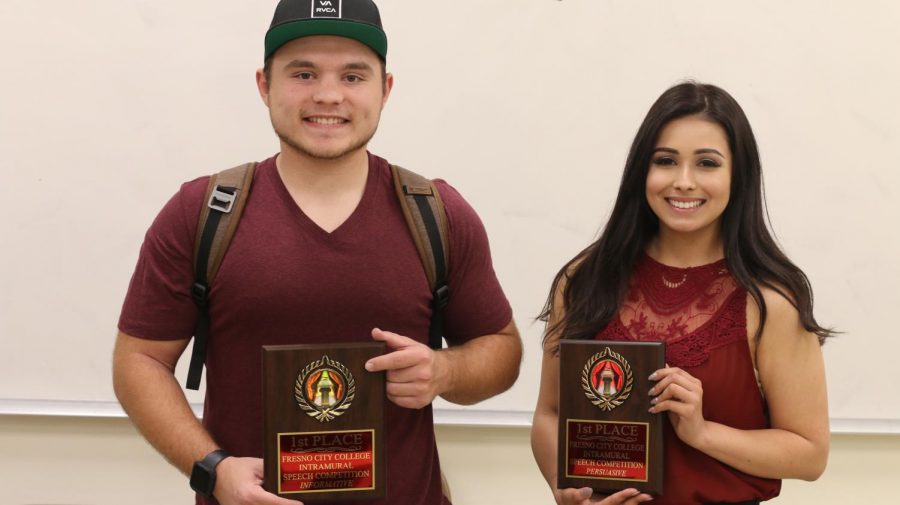 Logan Harris (left) and Stephanie Saavedra (right) posing together after receiving their first place trophies in the informative and persuasive categories.